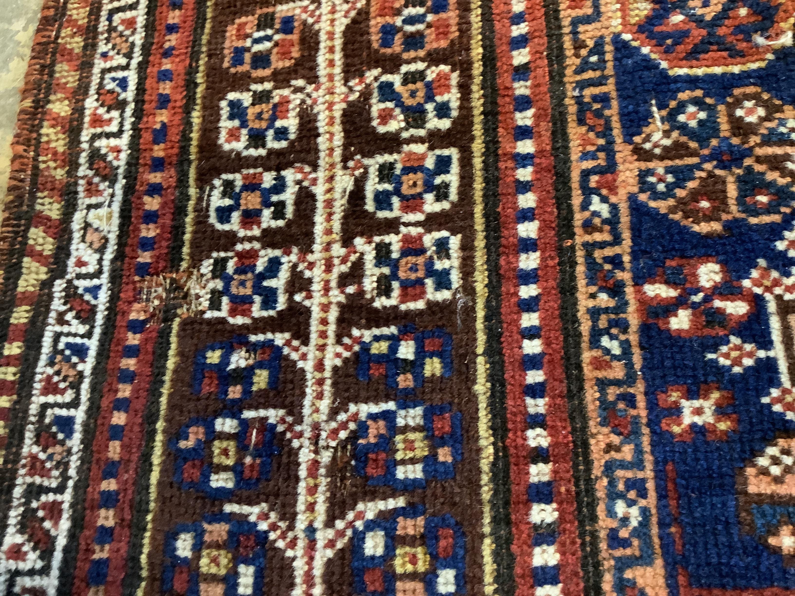 An antique Qashqai red ground rug, 260 x 174cm